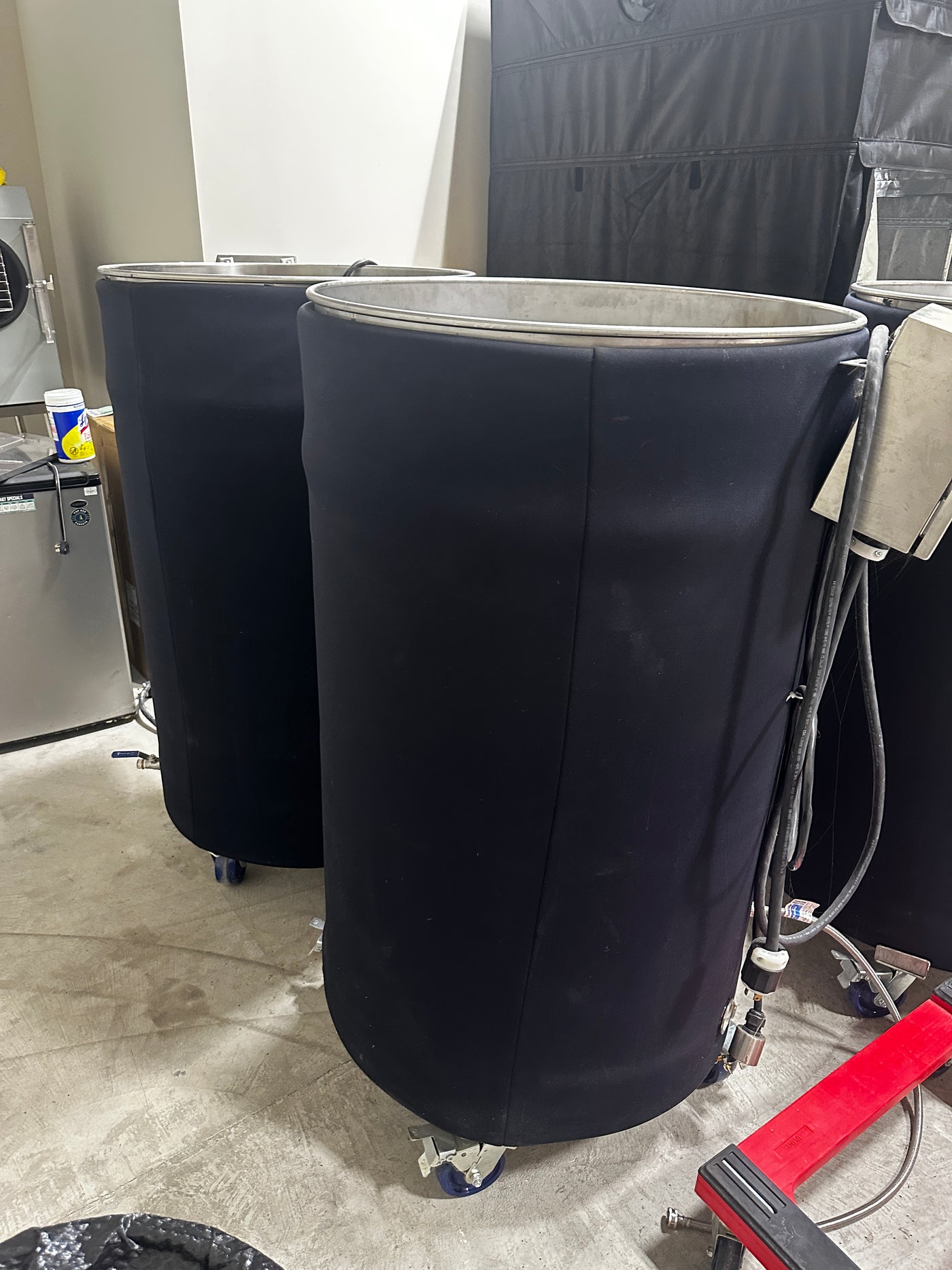 Two 150-gallon atmospheric steam sterilizers on dollies
